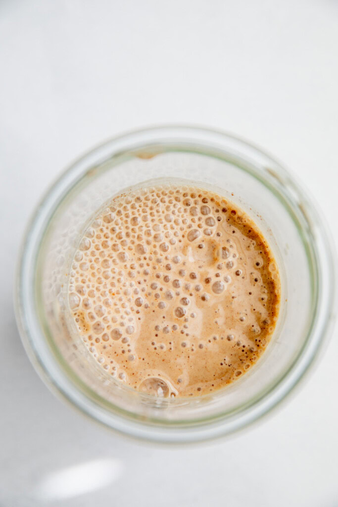 Blended apple milk in a blender cup.