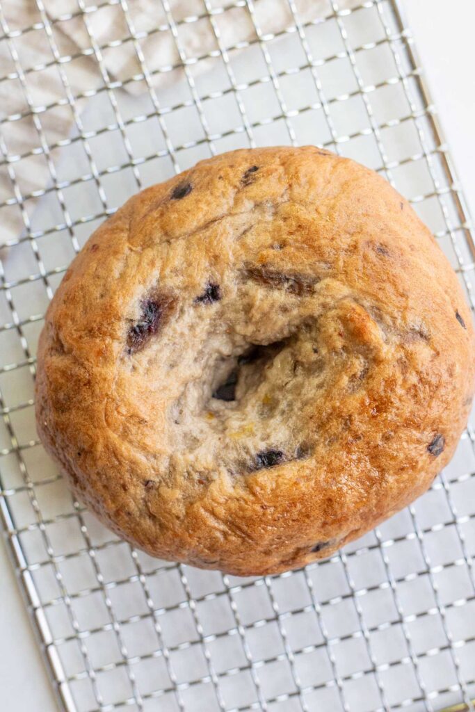 Blueberry bagel after baking on a wire rack.