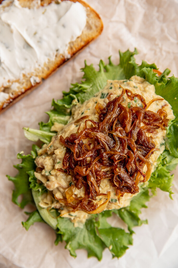 Toast layered with lettuce, chickpea salad, caramelized onions.