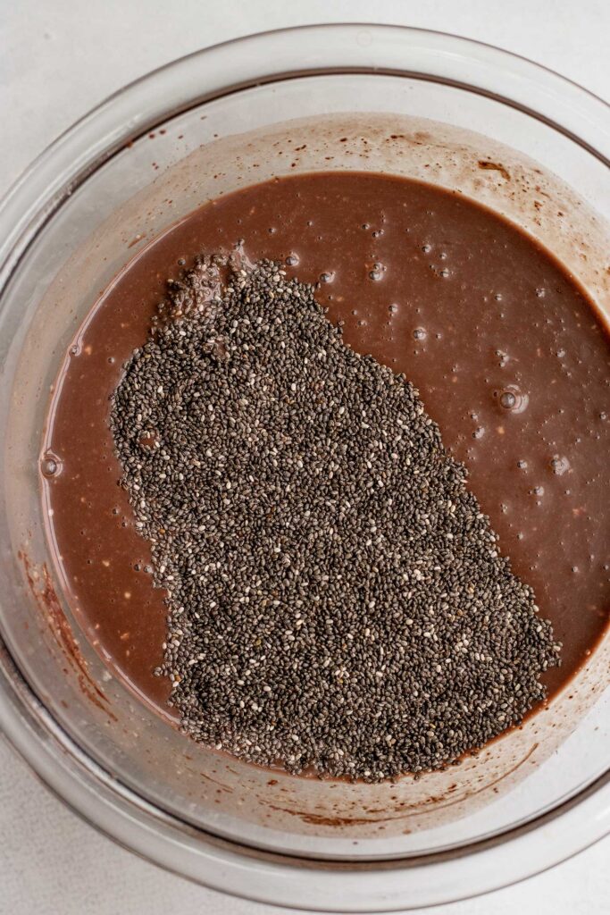 Folding in the chia seeds into the chocolate mixture.