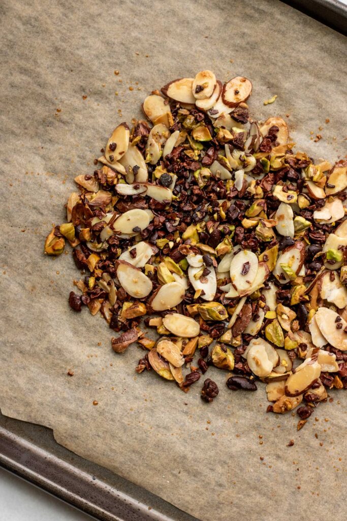 Golden baked crunchy nut seed mix on parchment paper.