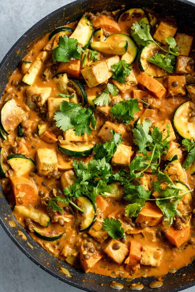 Topping stew with fresh cilantro.