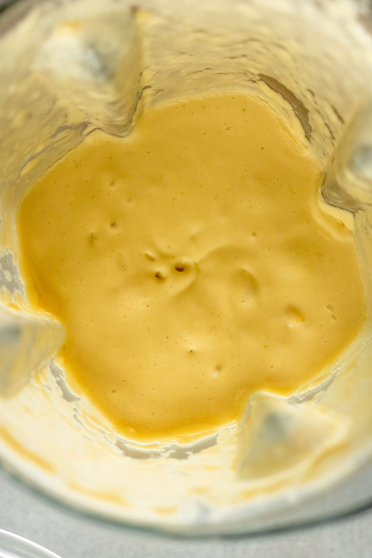Blended mango milk in a blender.