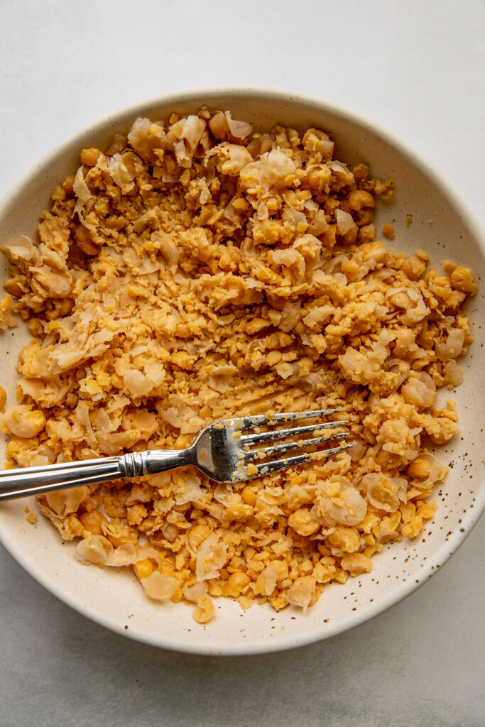 Mashed chickpeas in a bowl.