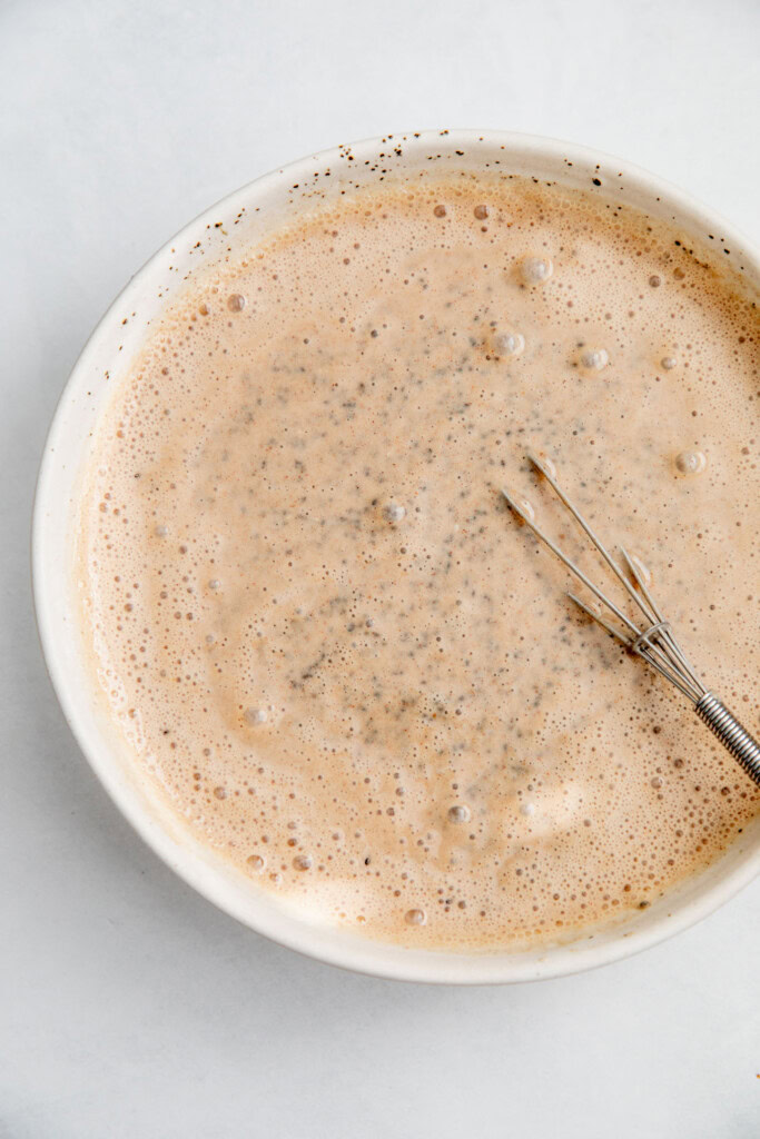 Mixing the apple milk with the chia seeds in a bowl.