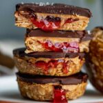 A plate stacked with 4 peanut butter and jelly oatmeal cups.