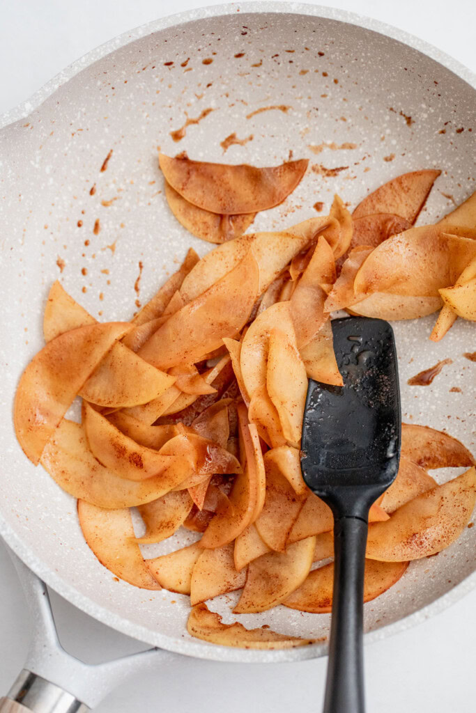 Sauteing the apples together until softened in a pan.