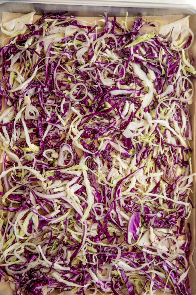 Seasoned cabbage on a tray.