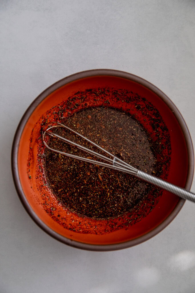 Bowl of whisked tamari, maple and spices.