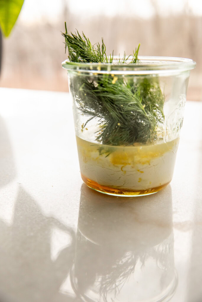 Yogurt, lemon, garlic, and dill in a jar ready to blend.