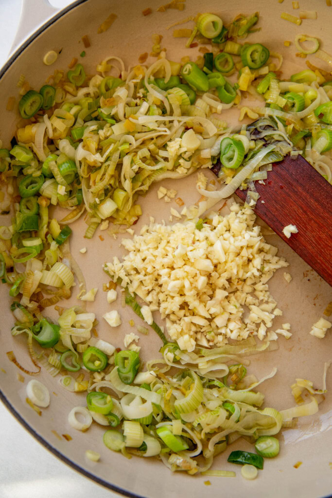 Sauteing the garlic in with the leeks and scallions.