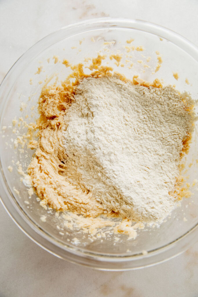 Adding the flour to the wet sugar mixture.