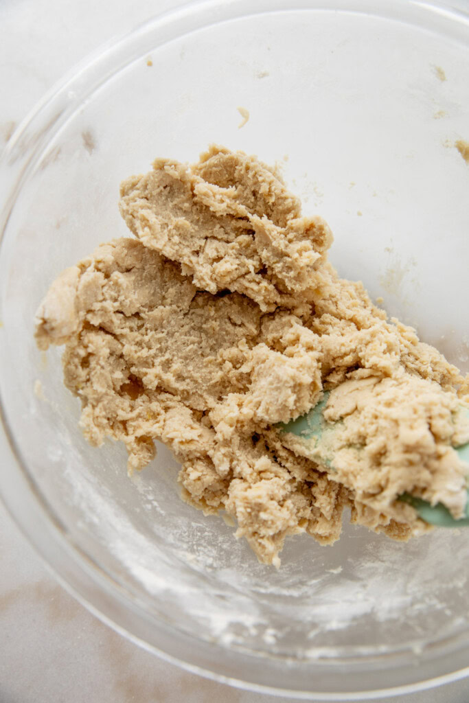 Folding the flour into the wet ingredients into a dough.