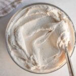 Top down view of a glass bowl with vegan cream cheese.