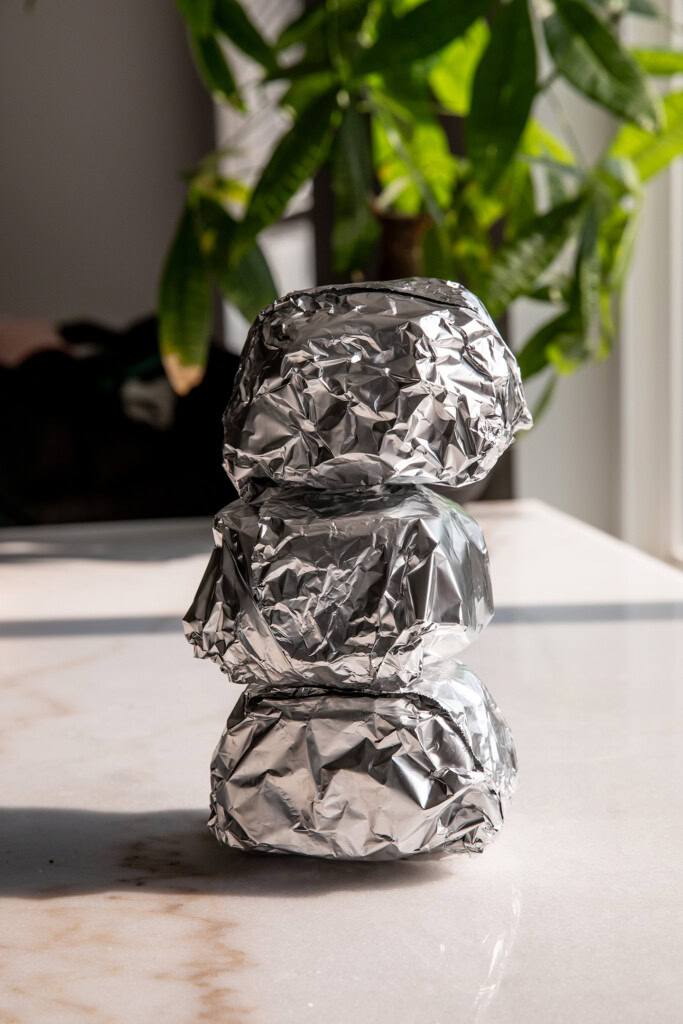 Wrapping the breakfast sandwiches in foil then stacking on top of each other.